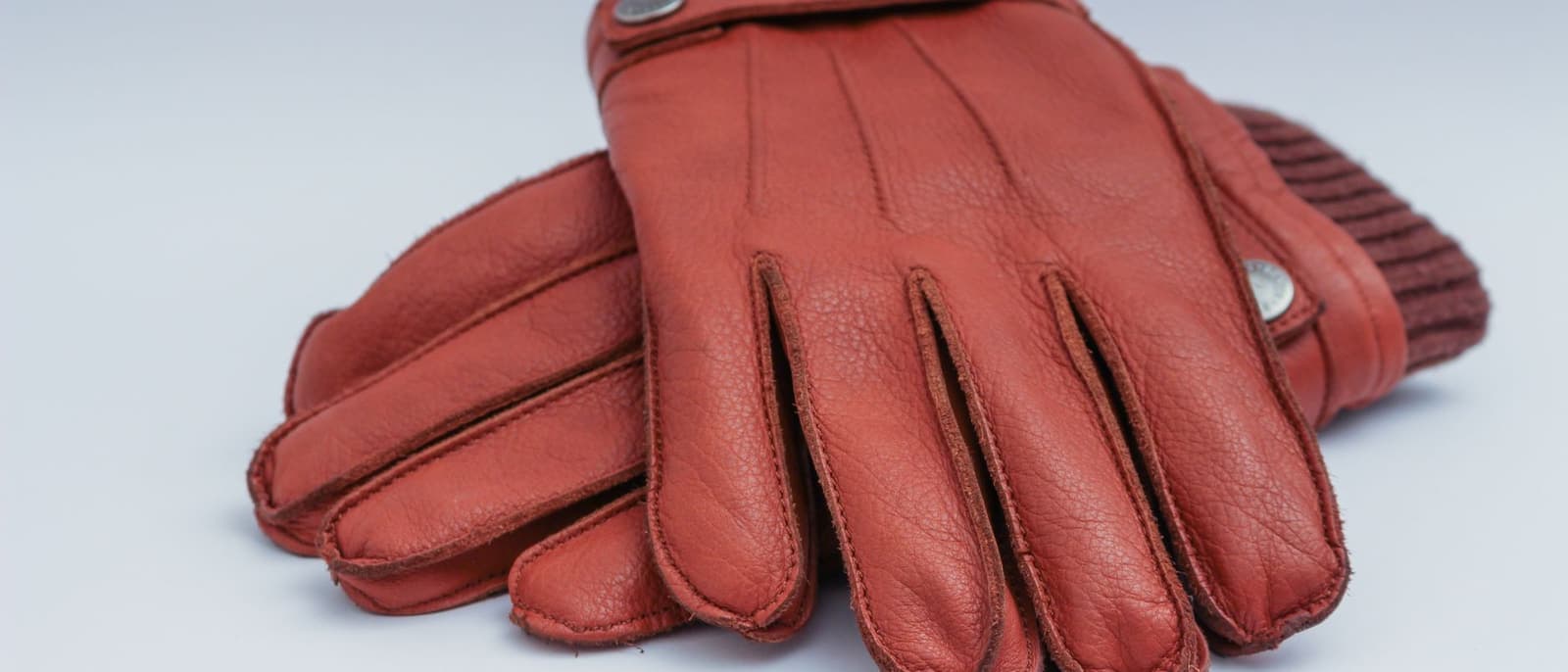 A pair of warm winter gloves photographed close up in soft daylight.