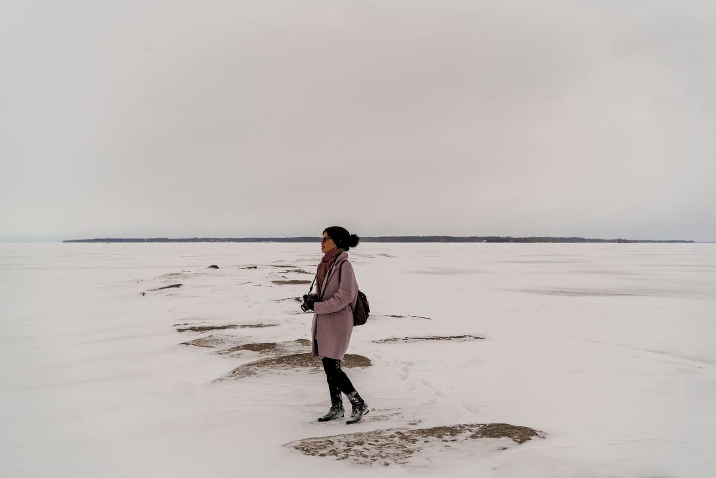 Boots on frozen ground under a pale overcast sky, the stationary winter cold heated socks are bought for.